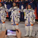 De izquierda a derecha, los astronautas chinos Zhang Hongzhang, Wu Fei y Zhang Lu, de la misión Shenzhou 21, en el Centro Jiuquan en el noroeste de China, el 31 de octubre de 2025. (AP foto/Andy Wong)